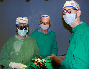 Dr. Cliff Moore (centre) scrubbed in assisting surgeons Dr. Adil Ladak (left) and Dr. Stan Valnicek.