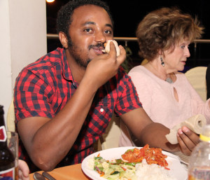 Rotaract Club President Yohannes demonstrates the fine art of eating with native Ethiopian Indira