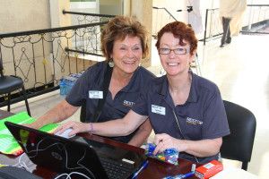 Mission Director Jean Bird sets up registration with Deb Nolan.